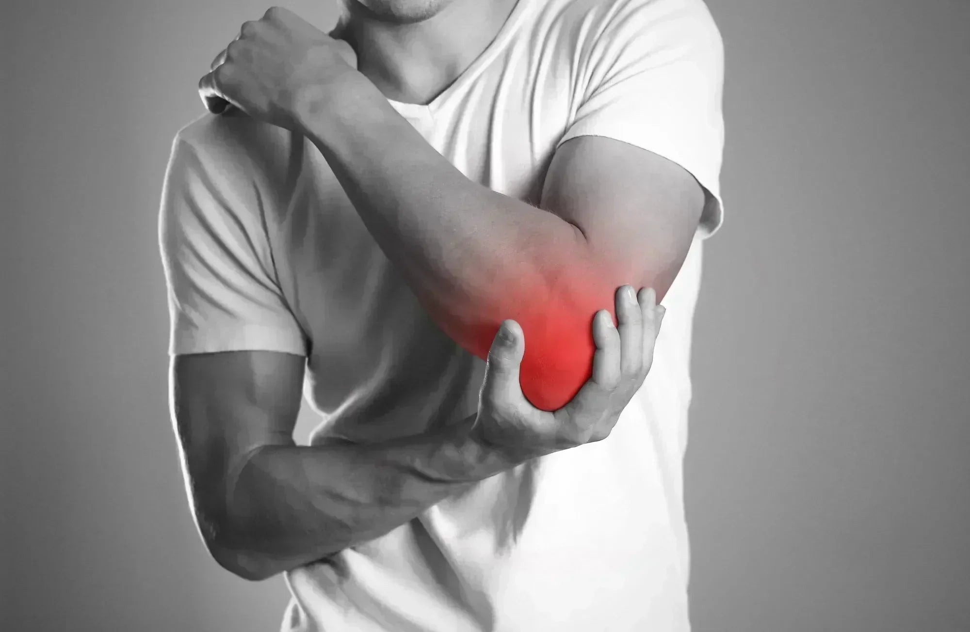 Person holding elbow with red highlighted pain area, symbolizing elbow pain or injury