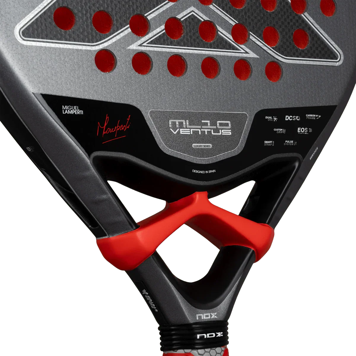 Close-up of a black and red padel racket with visible branding on a white background